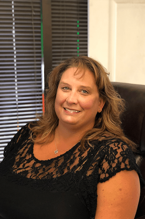 Melinda, co-owner of Caropractor, smiling in the shop office.
