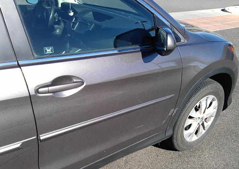 After: the same door, smooth, in the same parking spot.